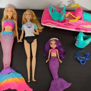 Barbie with jetski, lifevest and snokel gear plus two mermaid Barbie dolls